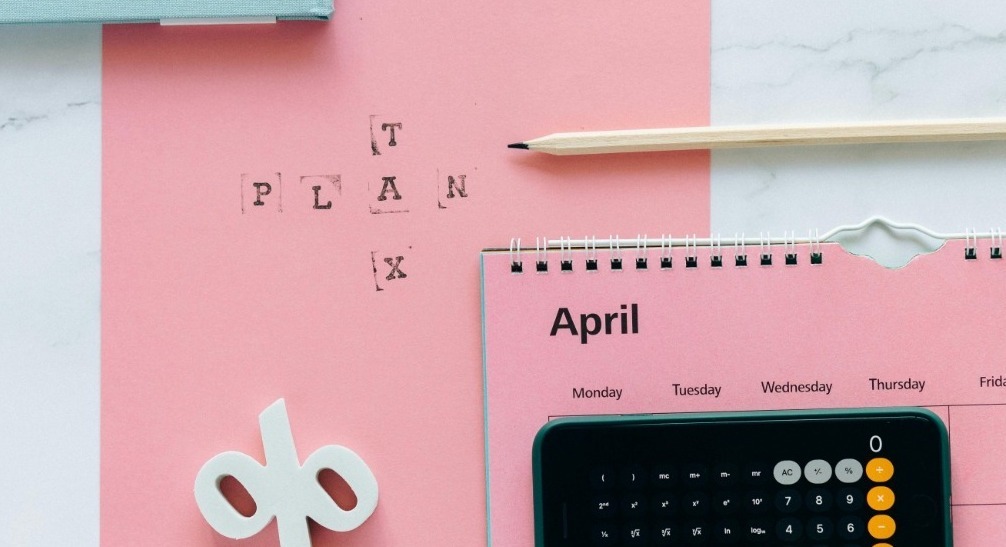 Pink Tax Plan Folder, White pencil, Pink April Month Calendar. iPhone calculator