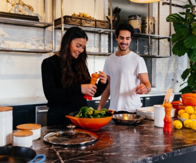Young couple cooking in kitchen