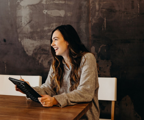 Young woman using tablet in lobby